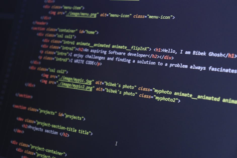 A detailed close-up photograph of a computer screen displaying colorful lines of JavaScript code, including variables, functions, and syntax in various colors such as red, green, blue, yellow, and whi